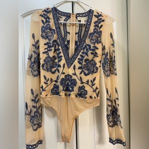 Never worn body suit, added layer of fabric under chest/stomach area.